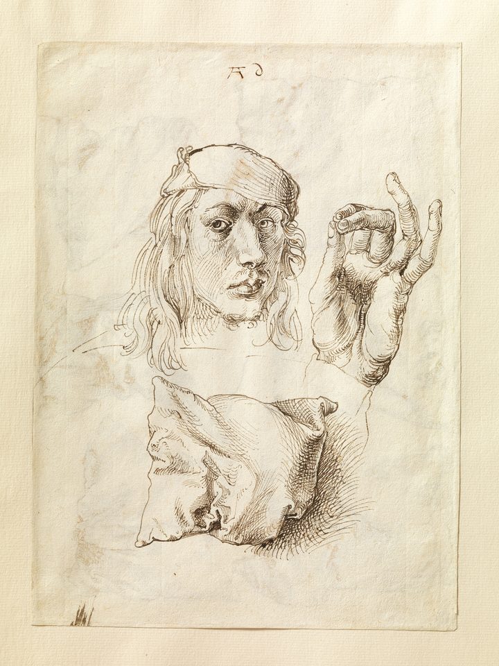 A Dürer pen drawing: the artist’s self-portrait, a hand and a pillow on one sheet, finely hatched.